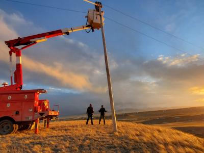 fergus electric working on a powerline in the sun